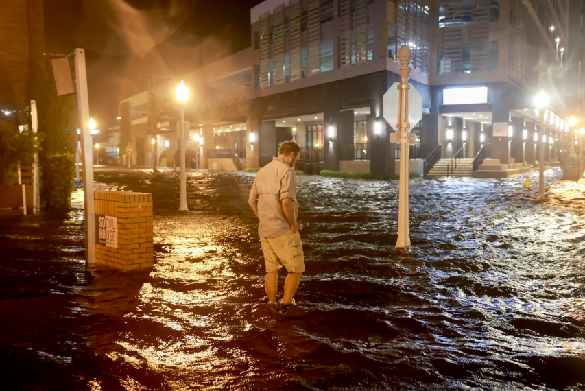 Brandon Marlow walks through surge waters flooding the street after Hurricane Milton came ashore in the Sarasota area in Fort Myers, Florida. Joe Raedle/Getty Images

