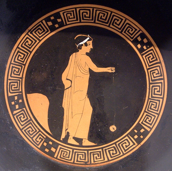 Greek Vase of a person playing with a Yoyo.