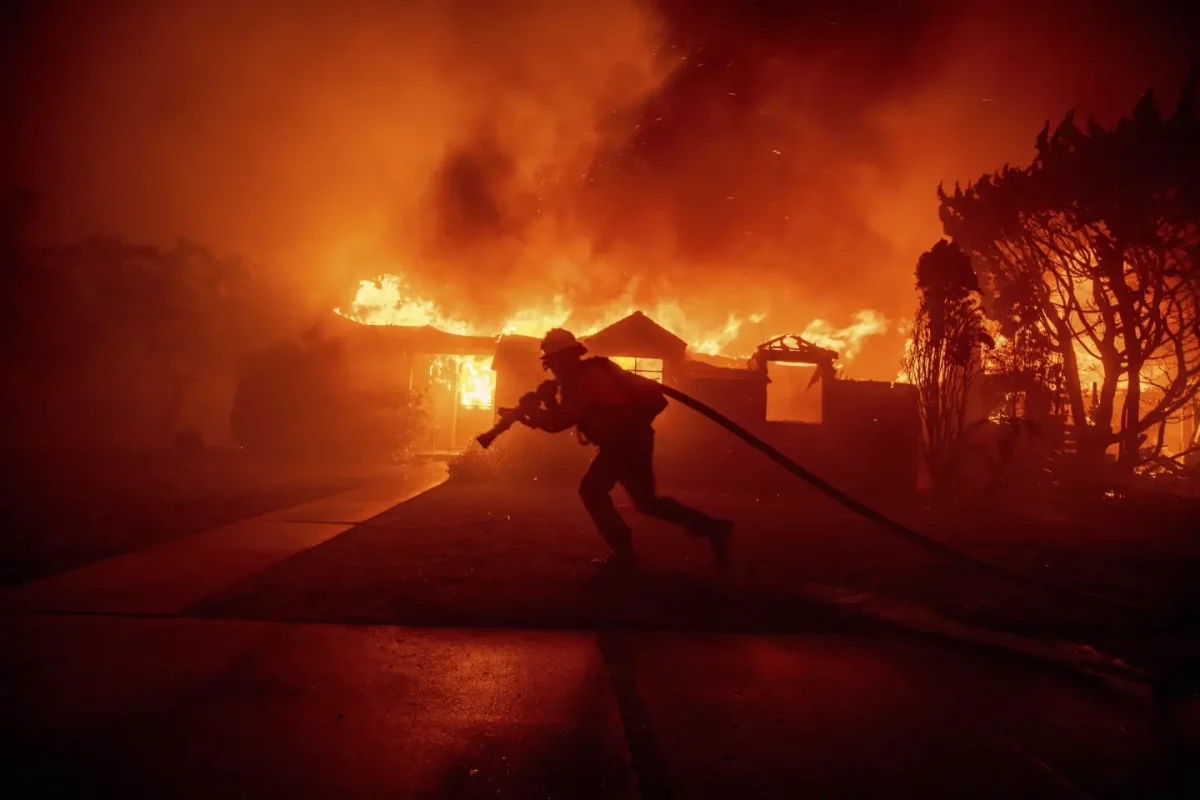 Firefighter battles structure fire in the Pacific Palisades neighborhood of Los Angeles; Jan. 7, 2025